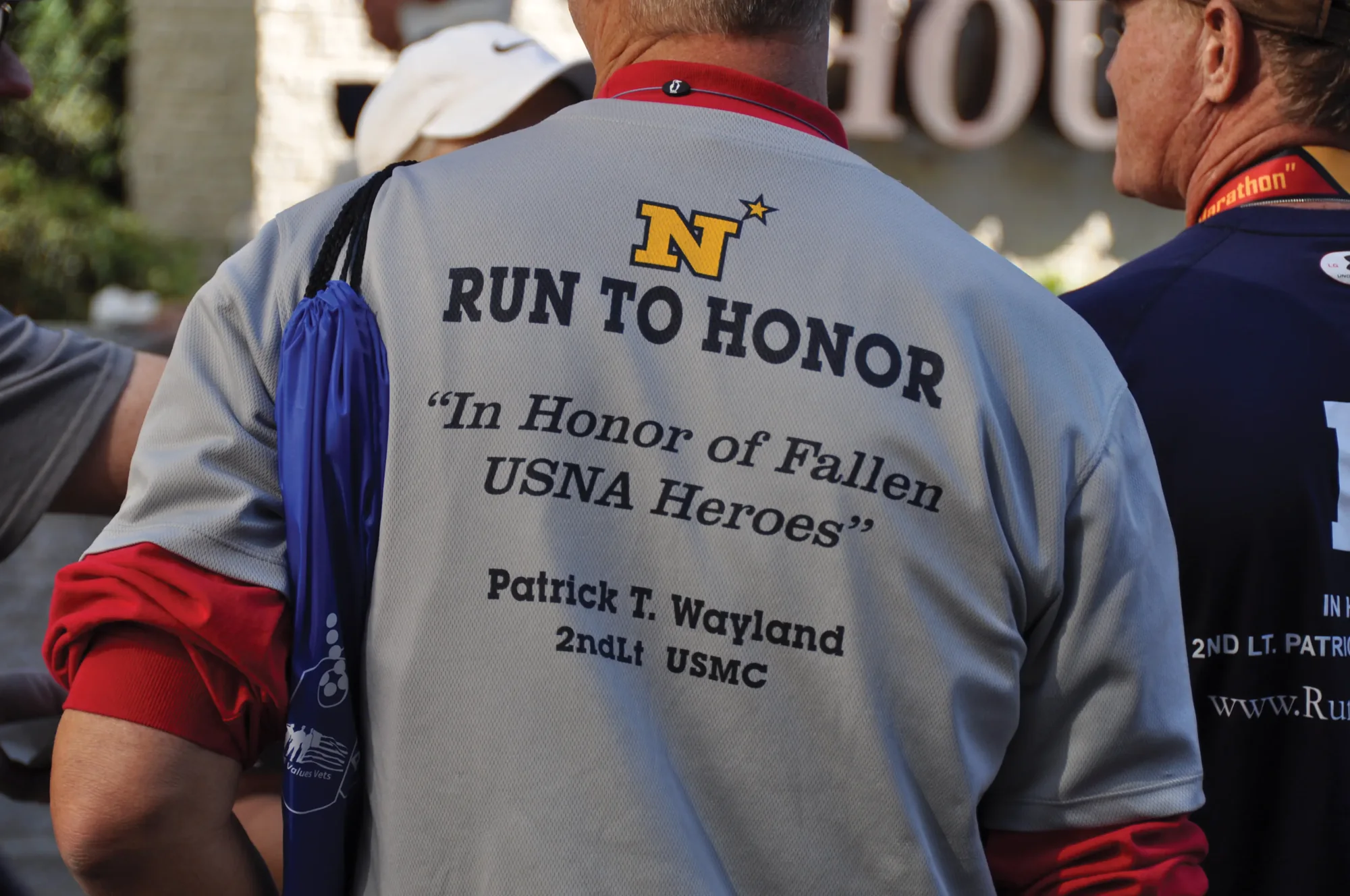The back of a Run to Honor shirt reading “In Honor of Fallen USNA Heroes — Patrick T. Wayland, 2ndLt USMC.”