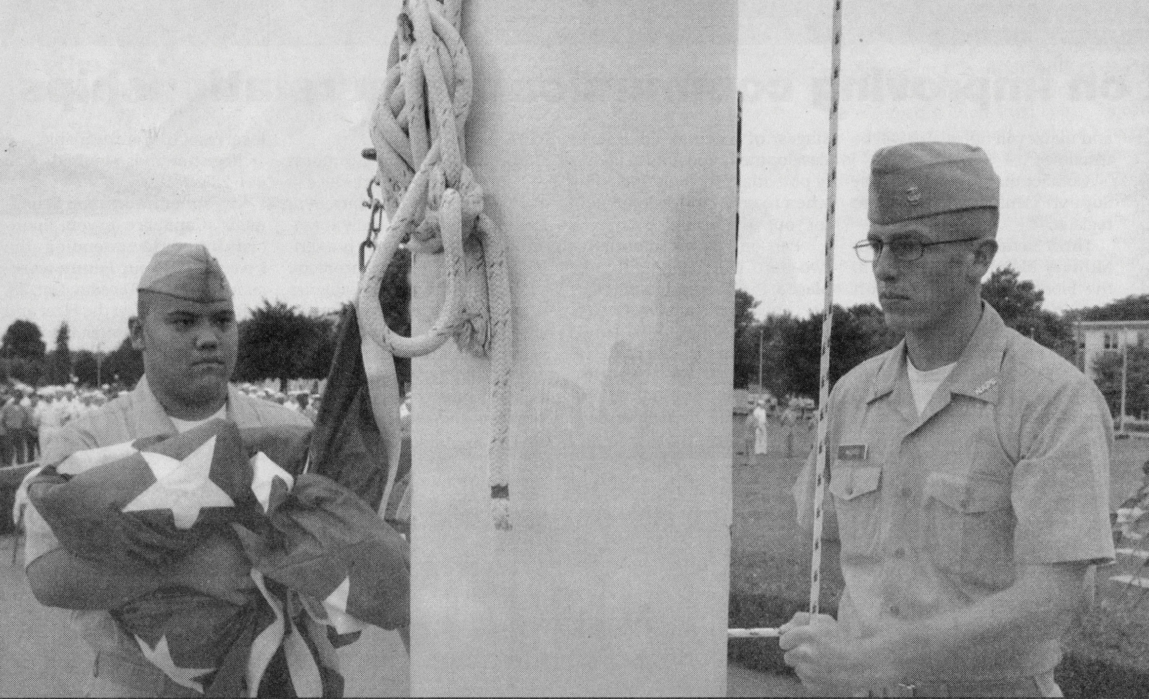 Joshua Angichiodo ’06, right, and a classmate prepare to raise the ensign during ceremonies in front of King Hall at NAPS